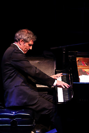 Aaron at piano looking down